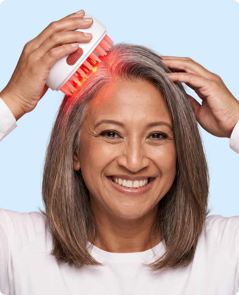 Woman using Scalpistry hair growth comb
