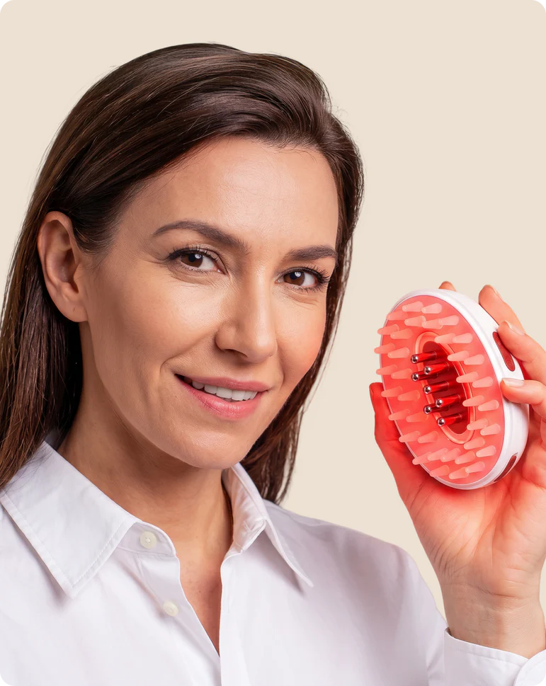 Woman using Scalpistry red light therapy comb
